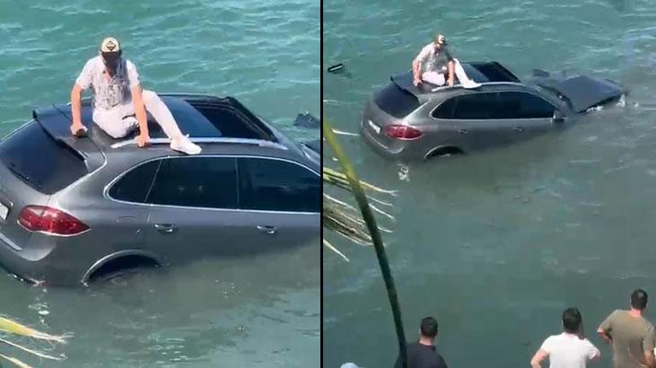 Arabasıyla denize uçtu, dakikalarca batan aracın üzerinde kurtarılmayı bekledi